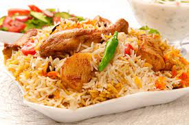 chicken biryani (an exotic preparation of rice tender paces of chicken and eggs )